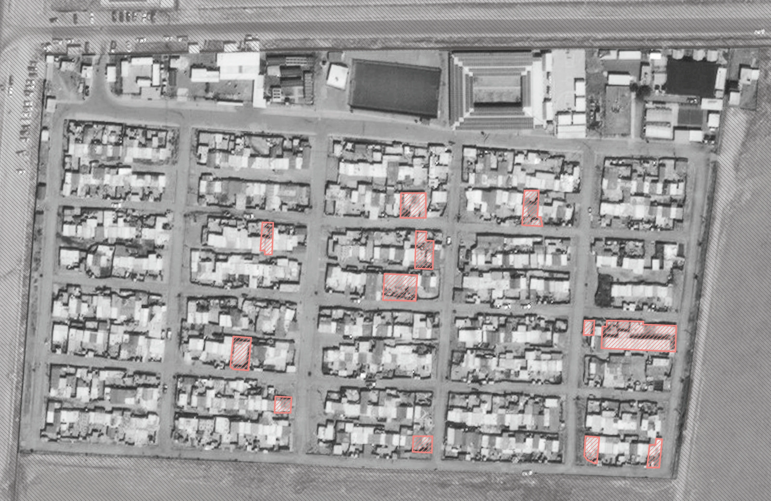 Satellite image of the camp’s grid of plots, with the surveyed homes outlined in red.