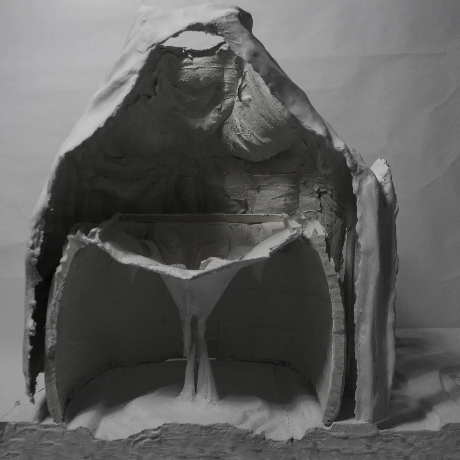 Black-and-white photo of a plaster shell cast cut in section, showing its thin wall.