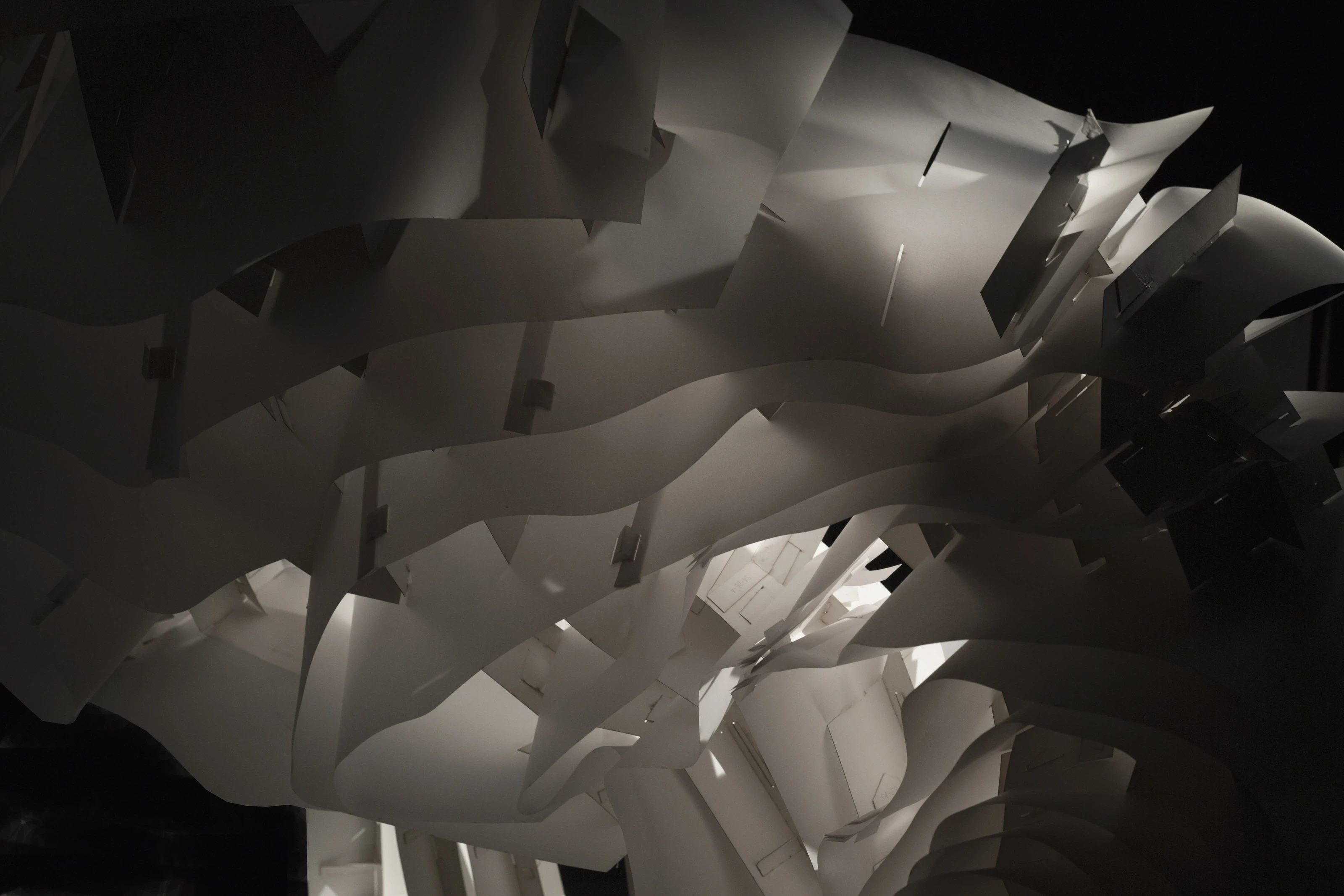 A view through the structure towards a dark opening.