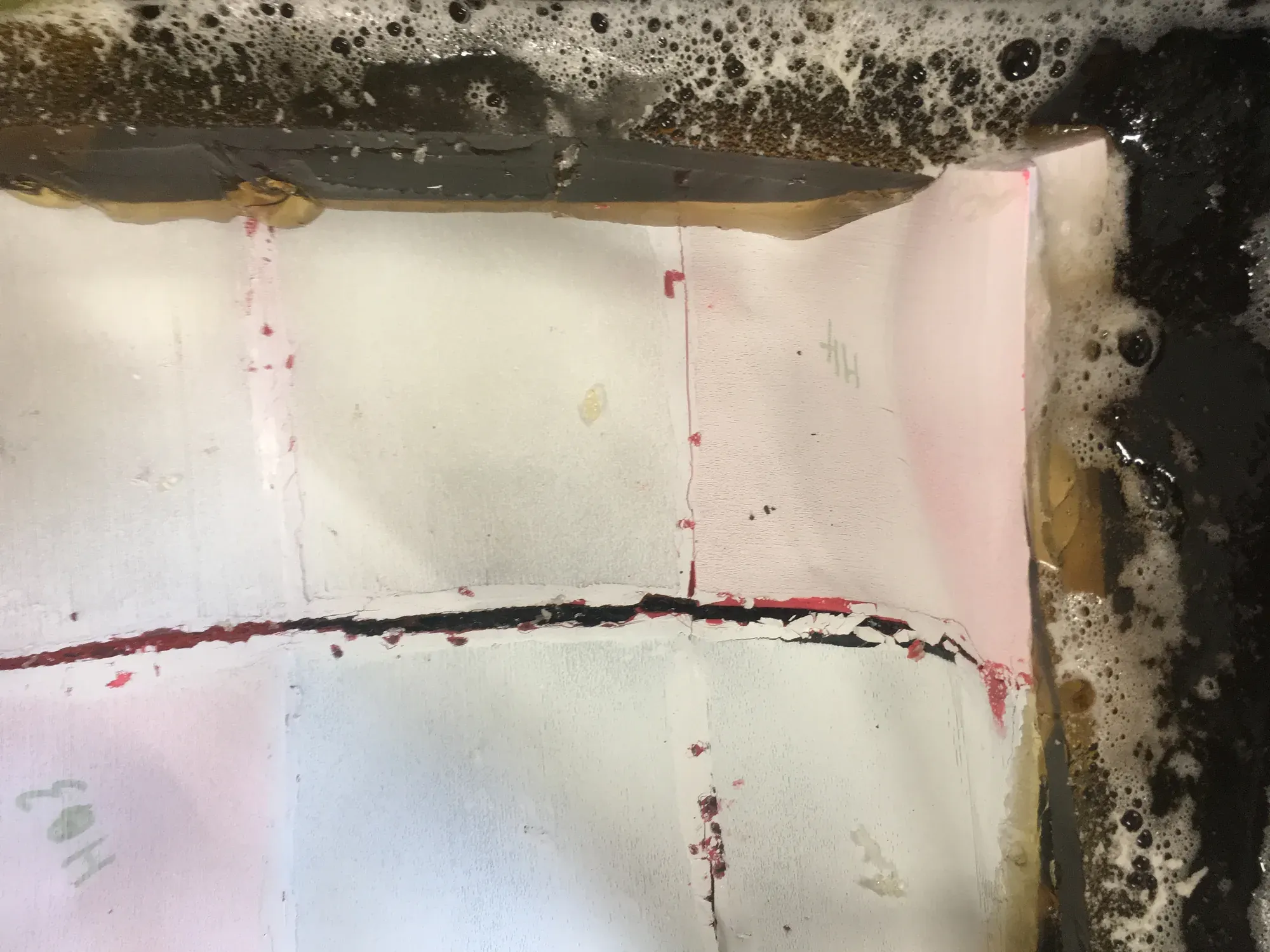 A white plaster surface in a tray with a red line marked across it.