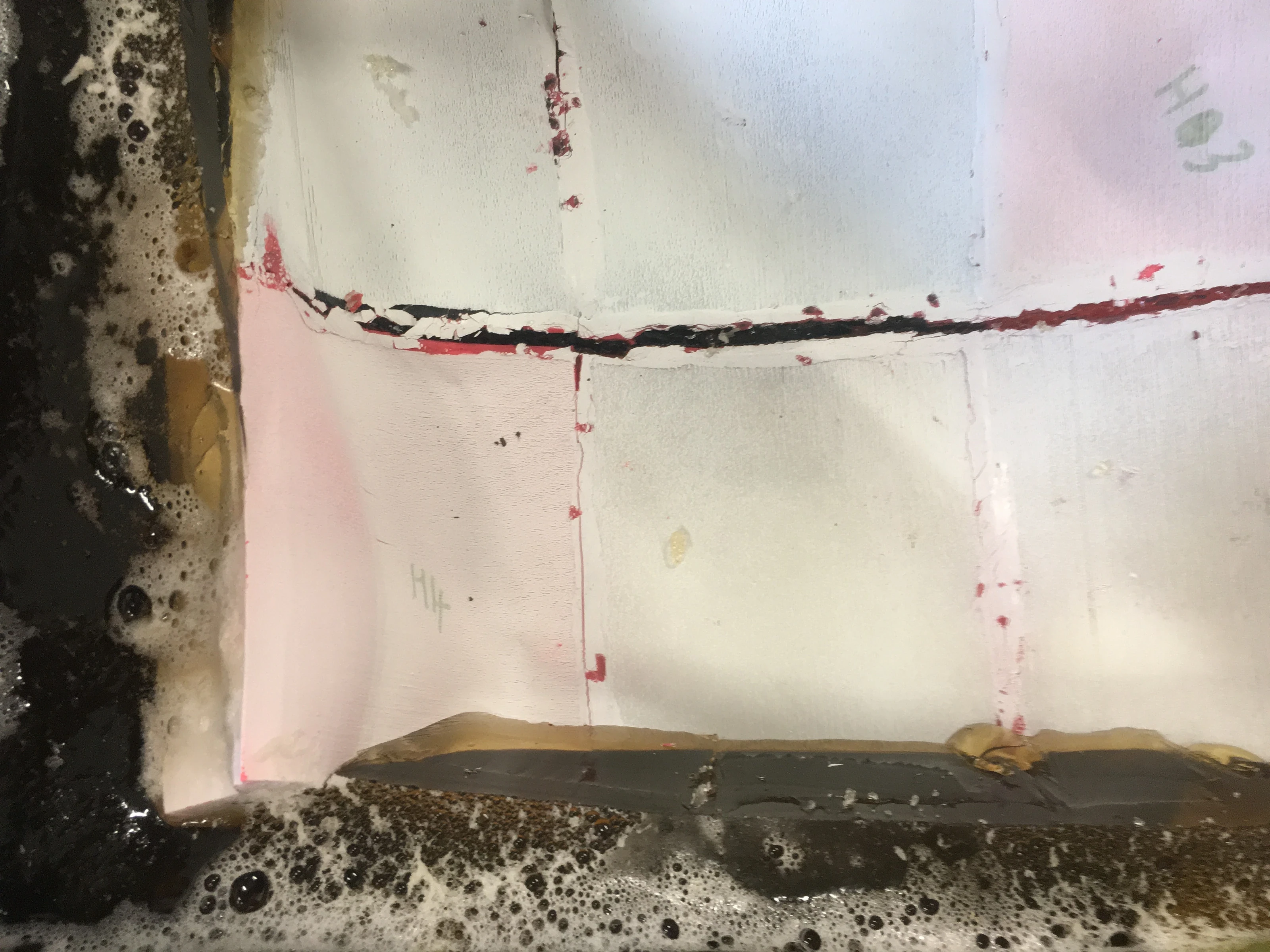 A white plaster surface in a tray with a red line marked across it.