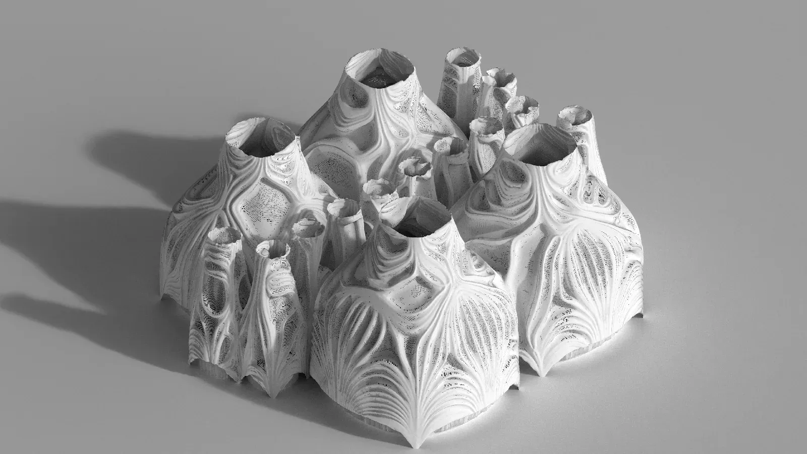 A white model of four clustered shell domes with deeply ribbed, flowing surfaces.